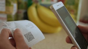 A man scans the QR code on a check from a supermarket. - Powered by Shutterstock - Get 15% off with code: PIKWIZARD15