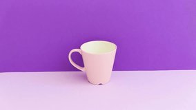 hand takes a pink mug with a drink. minimal