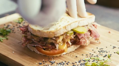Cutting and serving a pulled pork and mayo sandwich