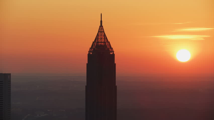 Dawn sunrise aerial view of the Bank of America Plaza and Art Deco style unique pinnacle spire at the top Atlanta city Georgia America Royalty-Free Stock Footage #1009915379