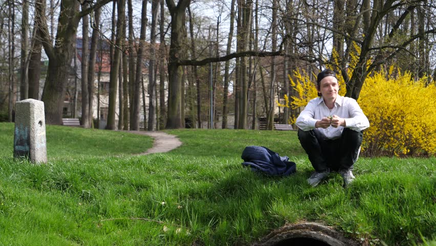 Young man sit relax admire spring nature in Wroclaw Poland park