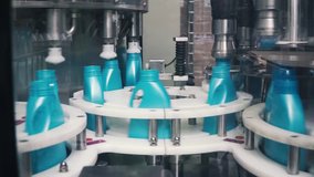 Liquid detergent on automated production line. Clip. Automated production line of washing fluid. Machinery for bottling