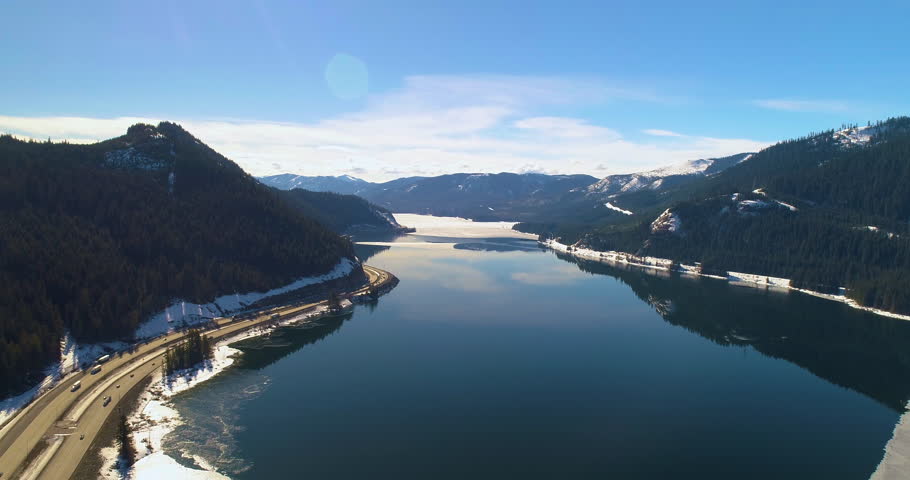 Aerial Frozen Lake Shore Above Snoqualmie Pass WA Interstate 90 Traffic