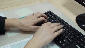 Woman typing on a keyboard. Close up. Clip. Close-up of hands typing on a keyboard in an office. hand on keyboard