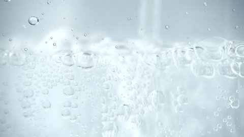Pouring transparent soda water in a glass - 4k