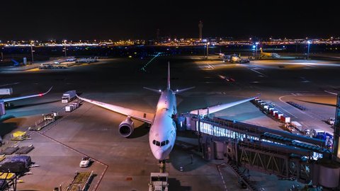 Tokyo, Japan - Apr 8,2018:Aircraft transportation traffic in taxiway at night in Haneda Airport time lapse.