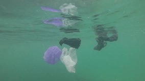 Plastic pollution in ocean. Environmental problem carrier bags,straws,cups and bottles dumped in sea. 