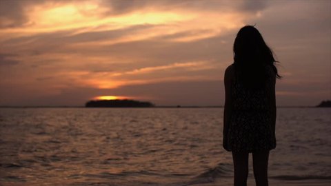 Cinemagraph Sad Girl viewing sunset in beach