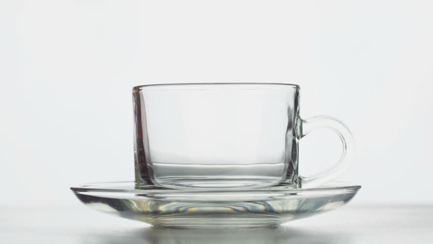 Steaming hot coffee pouring into a cup