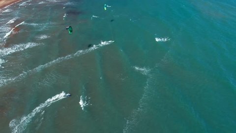 Aerial 4k slow motion with kite surfers in tropical blue ocean , kitesurfing from the sky  
