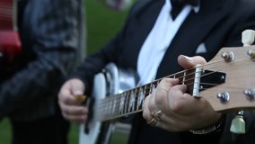 the guitar wedding man playing black. Cinematic wedding clip close up. Save the date shooting