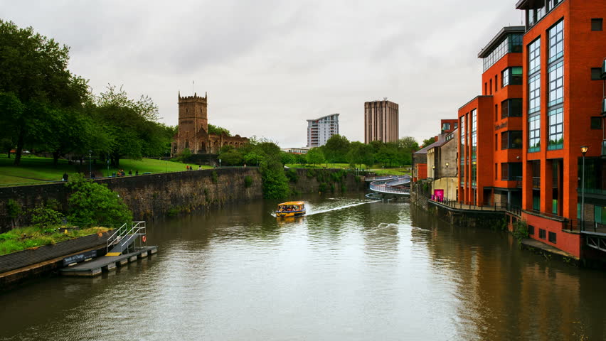 Bristol, UK. View of Castle park and St Peter church during the cloudy day. Time-lapse of boats on the canal in Bristol, UK. Catle bridge with cloudy sky