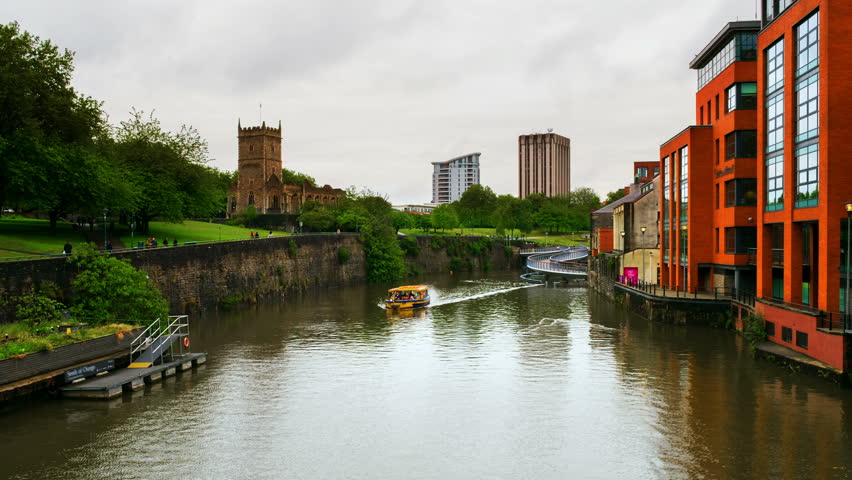 Bristol, UK. View of Castle park and St Peter church during the cloudy day. Time-lapse of boats on the canal in Bristol, UK. Catle bridge with cloudy sky. Zoom in
