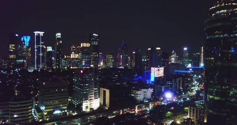 Beautiful aerial panorama of Jakarta downtown with skyscrapers and stunning night lights. Shot in 4k resolution