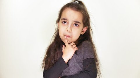Little cute girl guessing, wondering, thinking and looking at camera, portrait, white background 50 fps
