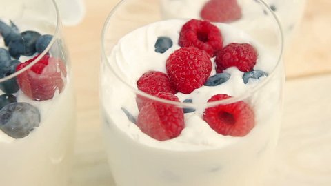 Healthy breakfast: yogurt cream with fresh blueberries and raspberries in a glass