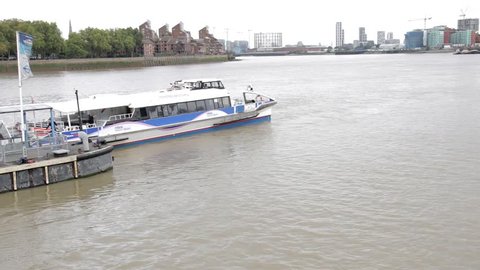 London, England – 04/12/18: A river bus heads downstream along the River Thames after leaving the jetty at Greenwich.