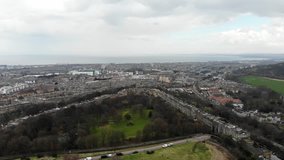 Aerial drone footage cityscape view of The City of Edinburgh in cloudy day, Scotland, United Kingdom.