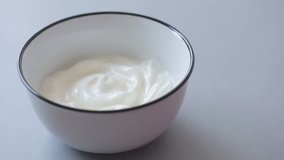 Food made of muesli mixed with fresh yogurth in the bowl slow tilt 4K 2160p 30fps UltraHD video - Healthy breakfast with muesli and milky yogurth tilting 4K 3840X2160 UHD footage
