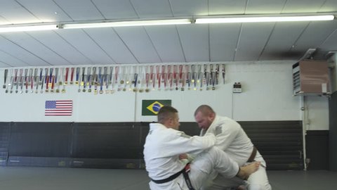 Mid adult men practicing Jiu-jitsu