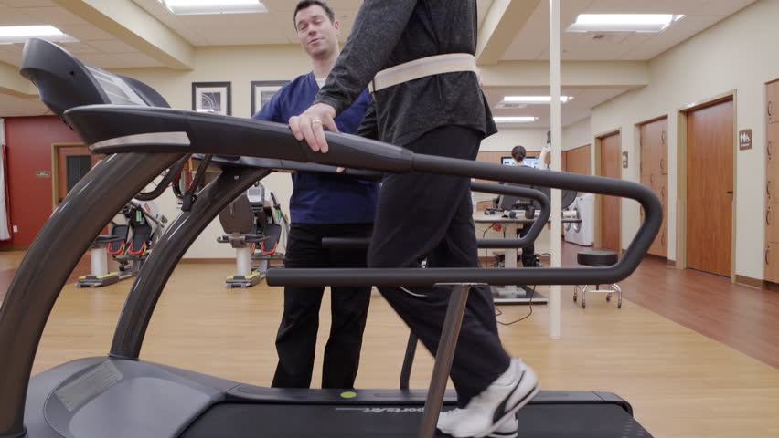 Medium shot of a senior man walking on a rehabilitation treadmill Royalty-Free Stock Footage #1009973054