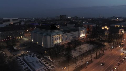 Aerial approach towards Estonian national opera house at night in Tallinn, Estonia