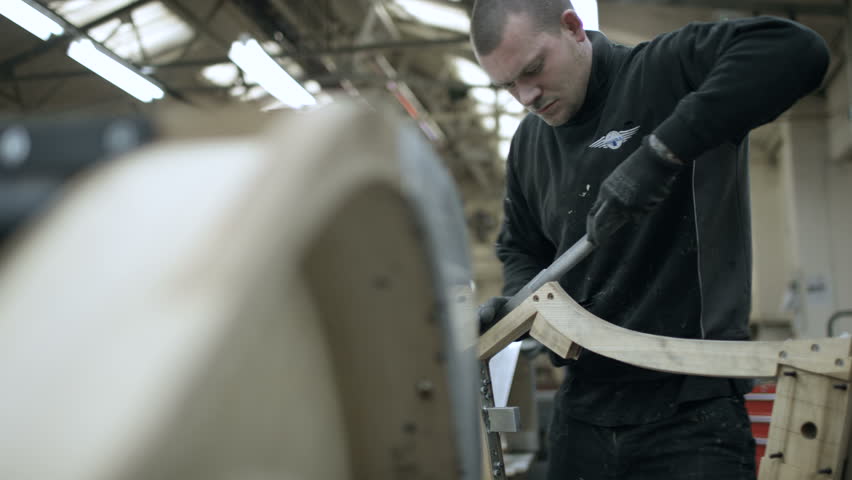 Automobile sports car manufacturing plant painters working on vehicles