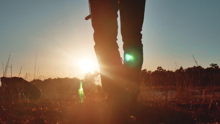 man tourist lifestyle are sitting by bonfire party in nature camping silhouette sunlight sunset. man silhouette on vacation cauldron lights fire 