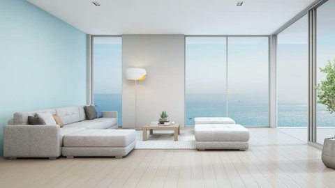 Sea view living room of luxury beach house with indoor plant near glass door and wooden floor deck. Big white sofa against blue wall in vacation home or holiday villa. Hotel interior 3d illustration.