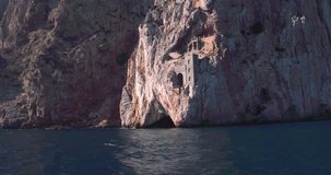 SARDINIA, ITALY – JULY 2016 : Video shot of building on cliff on Porto Flava beach on a sunny day, shot from a boat