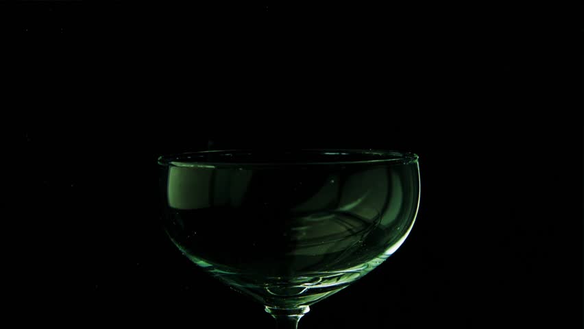 Beautiful glass goblet envelops thick green smoke. A magical and magical potion is poured into a glass vessel on a black background. Slow motion. Royalty-Free Stock Footage #1009998893