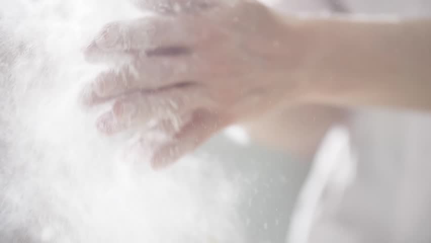 Chef clapping his hands filled with flour. Royalty-Free Stock Footage #1009999070