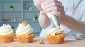 Decorating cup-cake with cream. Using cooking bag, confectioner making cupcakes for party. - Powered by Shutterstock - Get 15% off with code: PIKWIZARD15