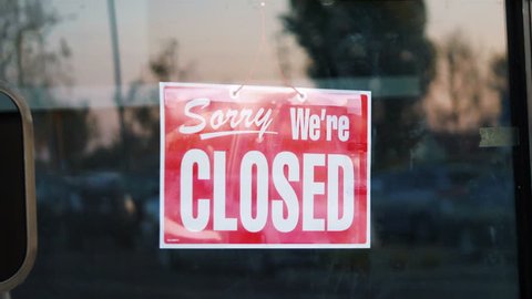 
Professional video of closed sign hanging on the door of a shop in 4k slow motion 60fps