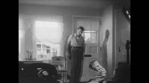 1940s: Man walks through room, tussles boy's hair. Man gets bottle out of refrigerator, woman places clothes into washing machine.