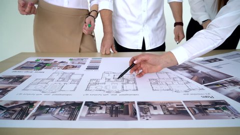 hands of architect group working with blueprint, business people on meeting presentation in office with construction engineer architect worker looking building model and blueprint plans 4k close up
