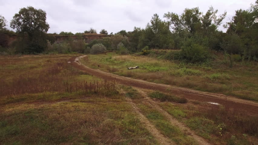 Aerial view of motocross dirt track drone following motocross riders off-road 4k