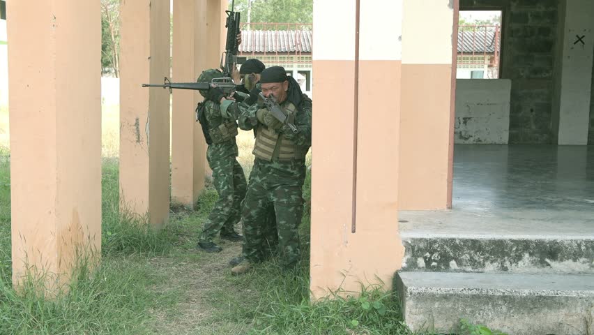 Special force soldiers in urban combat training.  Breach and entry building. Chinese soldiers in full combat gear, green digital cammo. Modern combat and anti terrorist concept.