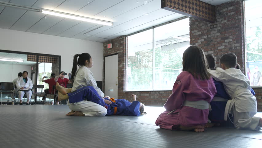 Teenage girls teaching Jiu-jitsu moves for children Royalty-Free Stock Footage #1010012159