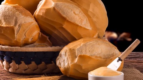 Basket of "French bread", traditional Brazilian bread and butter with fire background