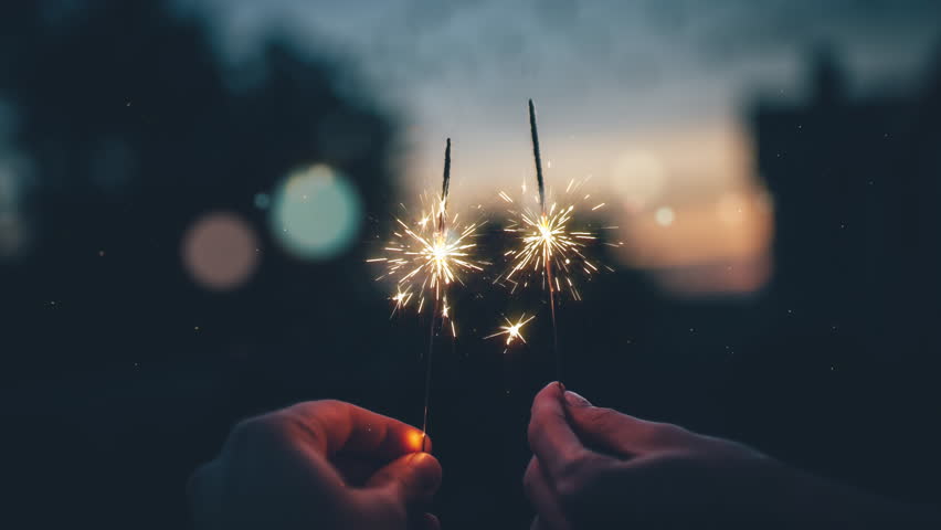 Cinemagraph 4K couple holding sparklers at the sunset in the rooftop watching the city lights. | Shutterstock HD Video #1010020853