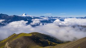 Aerial video with drone of the natural landscape of the valleys covered with clouds and the volcanoes Tronador and Puntiagudo in the background. Antillanca, Osorno, Chile