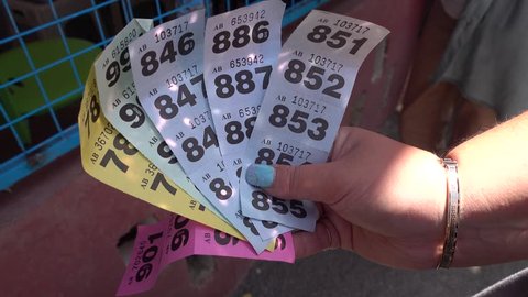 4K Raffle tickets in a female hand
