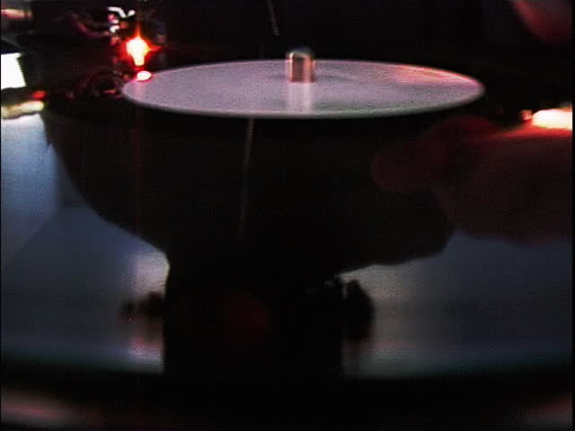 Close-up of hand scratching a record