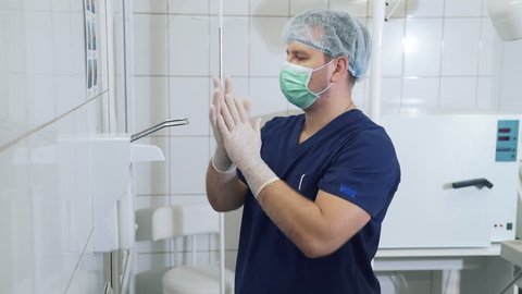 Doctor disinfects and washing his hands dry before entering the operating room. Surgical hand disinfection. Emergency care. Surgery detail in hospital or clinic