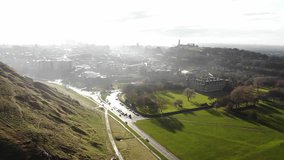 Aerial drone footage cityscape view of The Holyrood Park in cloudy day, Edinburgh, Scotland, United Kingdom.