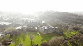 Aerial drone footage cityscape view of The Holyrood Park in cloudy day, Edinburgh, Scotland, United Kingdom.
