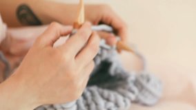 knitting on thick wooden knitting needles is a modern fashinable hobby. Warm toned film video footage
