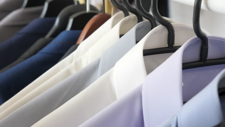 Hanger with male busines suits and shirt. Close up dolly footage Royalty-Free Stock Footage #1010055287