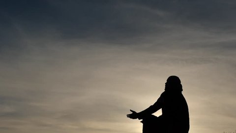 Prayer with putted forward hands silhouette